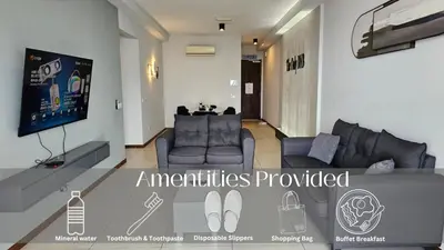 a living room with a couch and a tv at Family Seaview Suite with 3 Rooms by The Only Bnb in Tanjong Tokong
