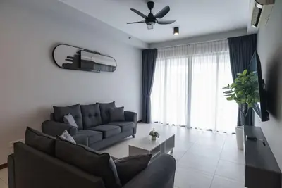 a living room with a couch and a ceiling fan at Family Seaview Suite with 3 Rooms by The Only Bnb in Tanjong Tokong