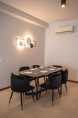 a dining room with a table and black chairs at Family Seaview Suite with 3 Rooms by The Only Bnb in Tanjong Tokong