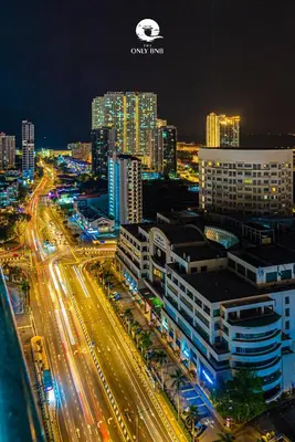 a city lit up at night with traffic on a highway at Family Seaview Suite with 3 Rooms by The Only Bnb in Tanjong Tokong