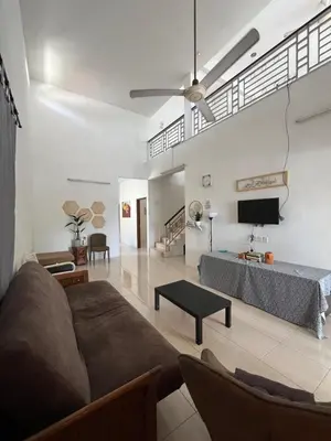 a living room with a couch and a table at Solehah Homestay in Seri Iskandar