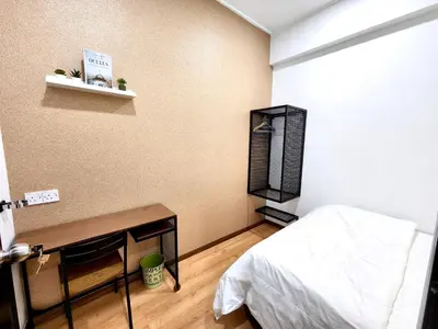 a small room with a bed and a table and a shelf at comfy 3-bedrooms with family karaoke Max-10pax in Ipoh