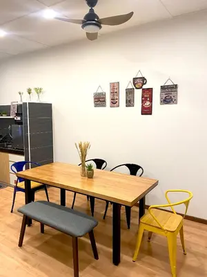 a dining room table with chairs and a ceiling fan at comfy 3-bedrooms with family karaoke Max-10pax in Ipoh