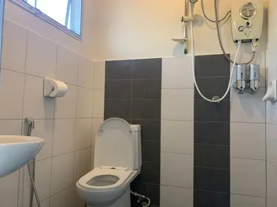 a bathroom with a toilet and a shower at Omari Marina Island Homestay Lumut in Lumut
