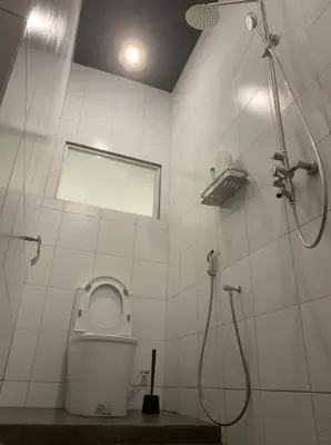 a white bathroom with a shower and a toilet at Kota Permai Free n Easy Interior Bukit Mertajam in Bukit Mertajam