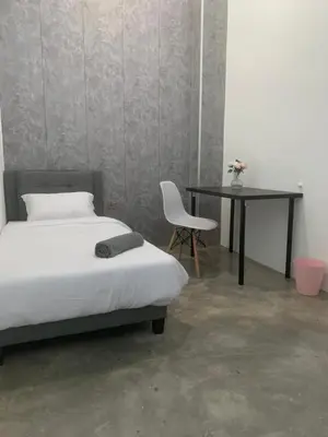a bedroom with a bed and a table and a chair at Kota Permai Mini Rest Room 99 Full Equipped in Bukit Mertajam