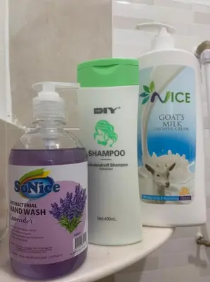 three bottles of cleaning products on a shelf in a bathroom at Kota Permai Mini Rest Room 99 Full Equipped in Bukit Mertajam