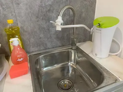 a kitchen sink with a faucet and a cup at Kota Permai Mini Rest Room 99 Full Equipped in Bukit Mertajam