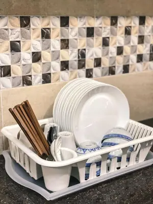 a tray with plates and dishes and chopsticks at Queen Room Bukit Mertajam Alma Impian in Bukit Mertajam