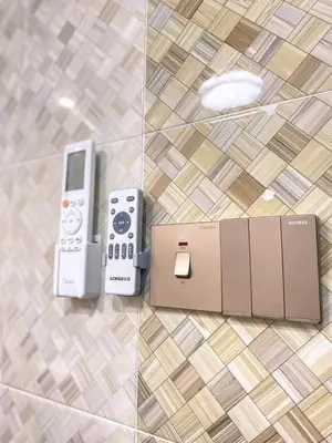 two video game controllers and a box on a floor at Queen Room Bukit Mertajam Alma Impian in Bukit Mertajam