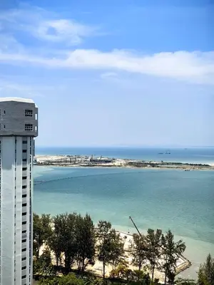 a view of a beach and a building and the ocean at LS Mansion One in George Town