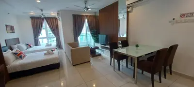 a room with a bed and a table and a bedroom at LS Mansion One in George Town