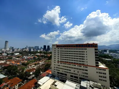 a tall white building with a city in the background at LS Mansion One in George Town