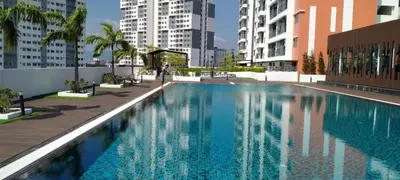 a large swimming pool in a city with buildings at Preferred30 3R2B 7pax Meritus Perai in Perai