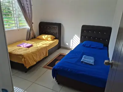 a bedroom with two beds and a window at Abah StayCation in Sungai Besar