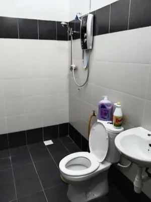 a bathroom with a toilet and a sink at Abah StayCation in Sungai Besar