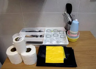 a table with toilet paper and a tray with cups at De cozy 5.0 Double storey (10-16 pax ++) in Ipoh