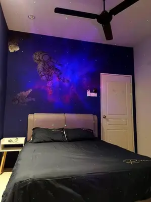 a bedroom with a bed with a painting on the wall at De cozy 5.0 Double storey (10-16 pax ++) in Ipoh