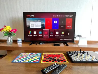 a computer monitor with a chess board and remote controls at Nova Mountain n Sunrise view Hilltop Hotel Apartment in Cameron Highlands in Cameron Highlands
