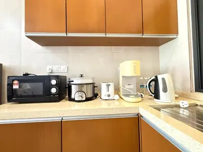 a kitchen counter with a microwave and appliances on it at Nova Mountain n Sunrise view Hilltop Hotel Apartment in Cameron Highlands in Cameron Highlands