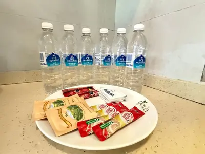 a plate with bottles of bottled water and food at Nova Mountain n Sunrise view Hilltop Hotel Apartment in Cameron Highlands in Cameron Highlands