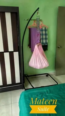 a room with a green wall with a green door and a bag at M Suite in Tanah Rata
