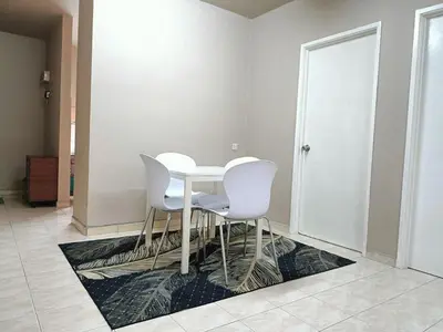a white table and chairs in a room at Homestay Wafiy Lost World Tambun Ipoh in Ipoh