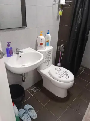 a bathroom with a toilet and a sink at Comfortable18 3R2B 7pax Meritus Perai in Perai