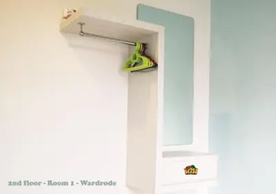 a mirror hanging on a wall with a hanger at H2H - CY Botani Vacation House (15pax) in Ipoh