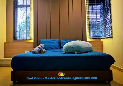 a blue bed with a stuffed animal on top of it at H2H - CY Botani Vacation House (15pax) in Ipoh