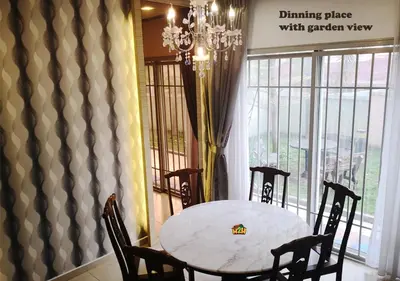 a dining room with a table and chairs and a chandelier at H2H - CY Botani Vacation House (15pax) in Ipoh