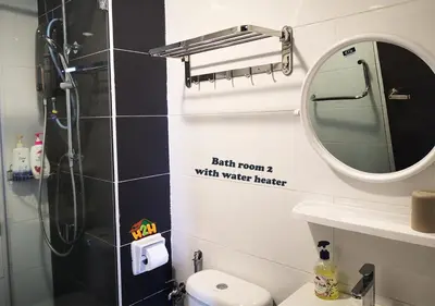 a bathroom with a shower and a sink and a mirror at H2H - CY7 @ Majestic Ipoh in Ipoh