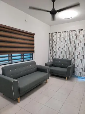 a living room with two couches and a ceiling fan at Acasa HS in Ipoh