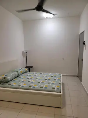 a bed in a room with a ceiling fan at Acasa HS in Ipoh