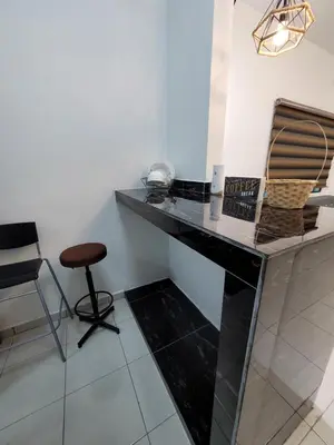a black marble desk with a chair in a room at Acasa HS in Ipoh