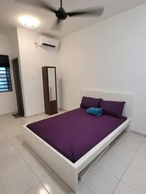 a bedroom with a bed with purple sheets and a ceiling at Acasa HS in Ipoh