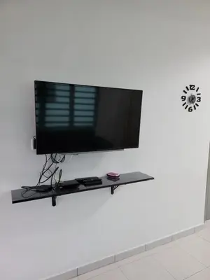 a flat screen tv sitting on a shelf in a wall at Acasa HS in Ipoh
