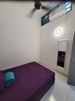 a bedroom with a purple bed and a mirror at Acasa HS in Ipoh