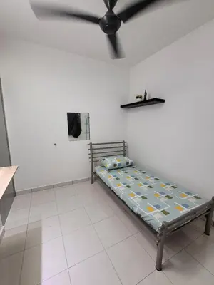 a bed in a room with a ceiling fan at Acasa HS in Ipoh