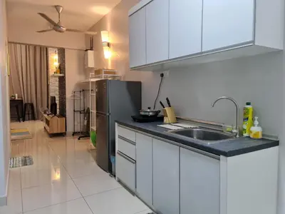 a kitchen with a sink and a refrigerator at Maritime Karpal Singh in George Town