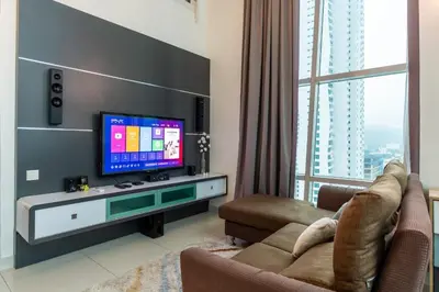 a living room with a tv and a couch at Maritime Karpal Singh in George Town