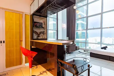 a living room with a red chair and a desk at Maritime Karpal Singh in George Town