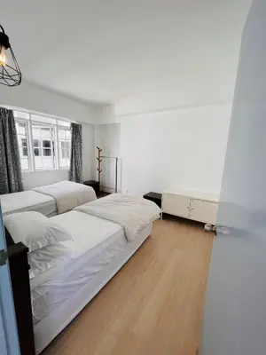 a bedroom with two beds and a wooden floor at The Antler Silverpark Fraser's Hill in Bukit Fraser