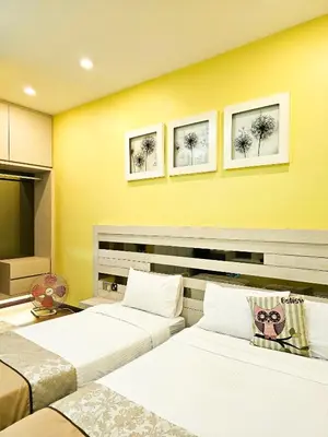 two beds in a room with yellow walls at Pearl Rice Garden Japanese Style \u7c73\u6a02\u574a\u9802\u5c64\u65e5\u5f0f\u9ad8\u7ea7\u516c\u5bd3 in Sekincan