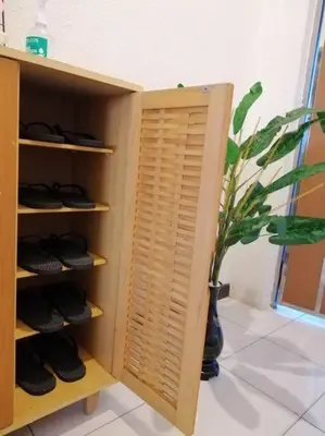 a book shelf with a plant in a room at InvincibleSeaview Batu Ferrighi Sri Sayang \u7121\u6575\u6d77\u666f 2-7 in Batu Ferringhi