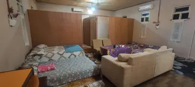 a bedroom with a bed and a couch and a chair at Afilia 2 in Kuala Kangsar
