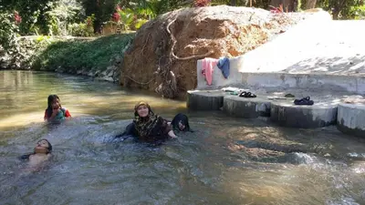 three people in the water at a water park at Afilia 2 in Kuala Kangsar