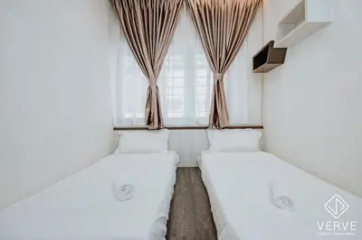 two beds in a room with a window at Ipoh Mansion House 21 by Verve (14pax) EECH74 in Ipoh