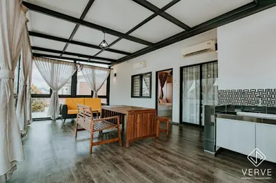 a kitchen and living room with a table and chairs at Ipoh Mansion House 21 by Verve (14pax) EECH74 in Ipoh