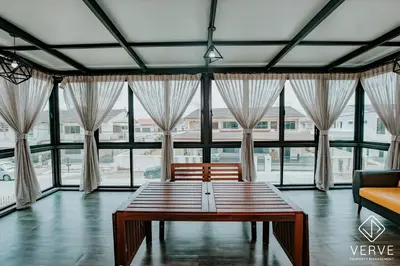 a living room with a table and large windows at Ipoh Mansion House 21 by Verve (14pax) EECH74 in Ipoh
